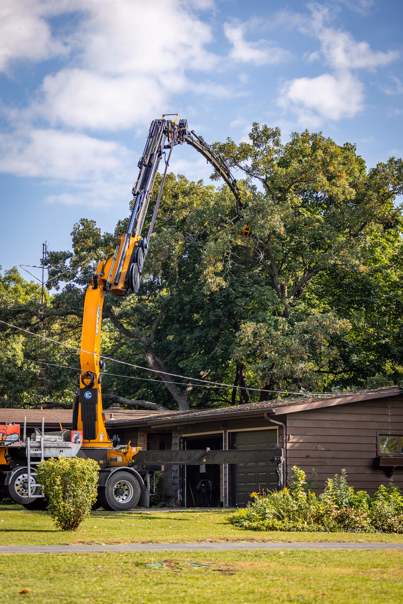 Grapple Saw Lifting a Limb Clear of a Roof